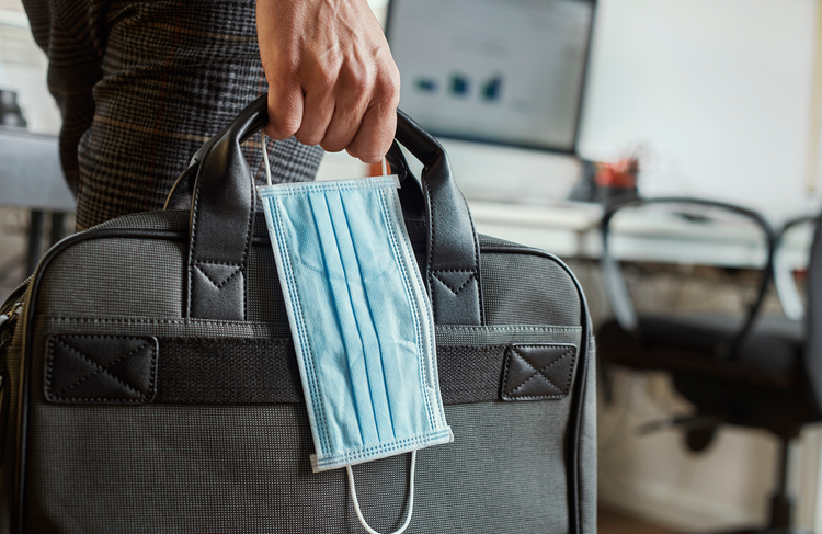 employee back to work with mask and bag